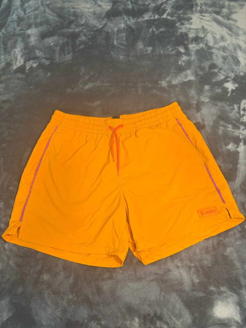 Cotopaxi orange swim trunks